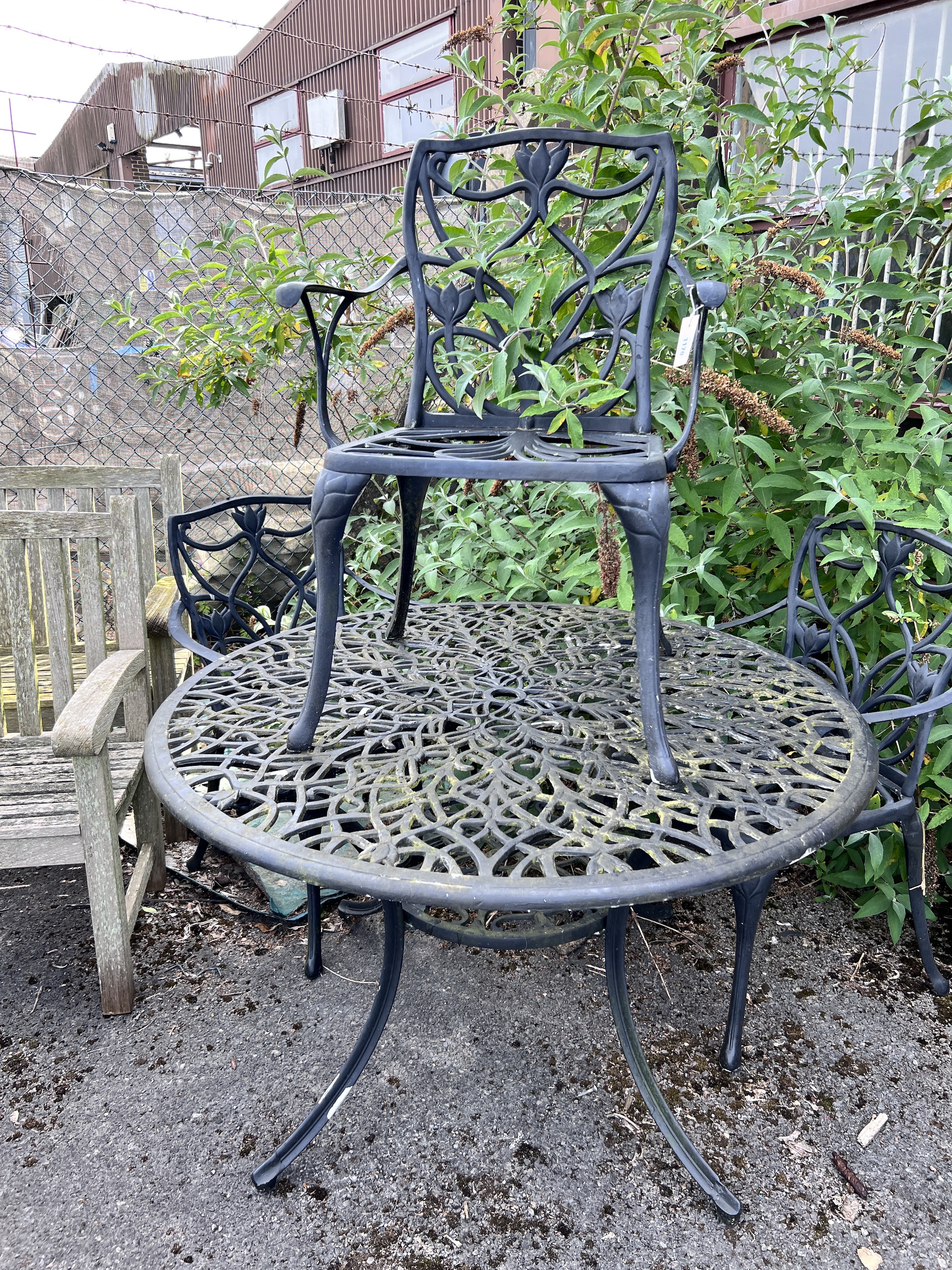 A circular painted aluminium garden table and three chairs, table 120cm diameter, height 72cm